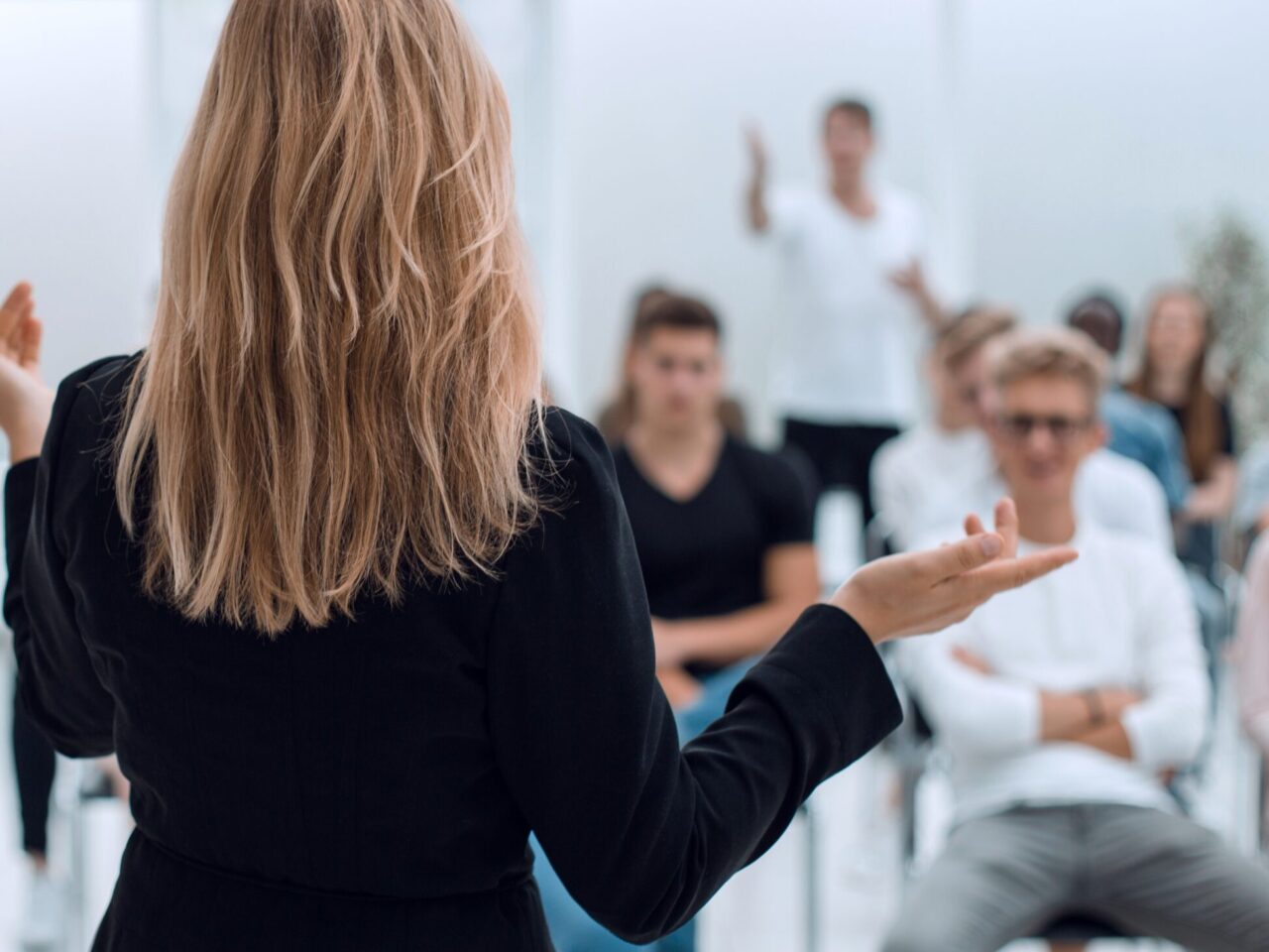 background image of a business seminar in a bright conference room